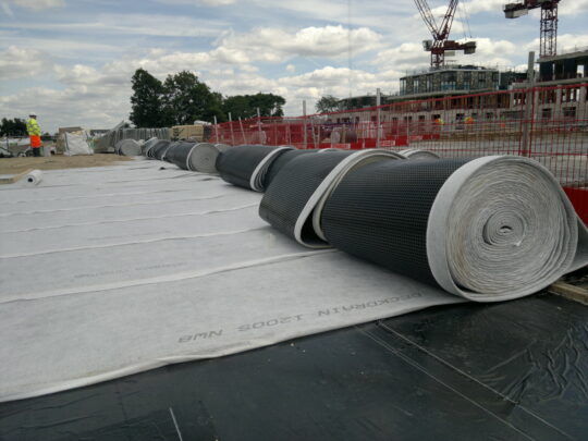 Small rolls of Deckdrain are quickly laid directly on the waterproofing for the concrete roof slab and walls