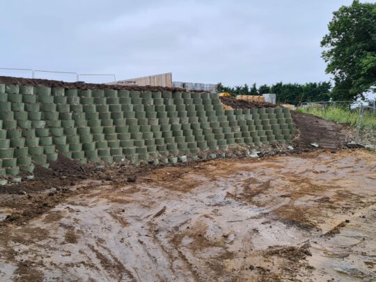 Type A panels to reach the retaining wall design height. Cells stepped back 100mm and filled with site won soils