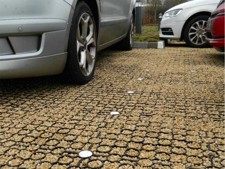 Gravel filled plastic paving grids for a car park providing SuDS drainage
